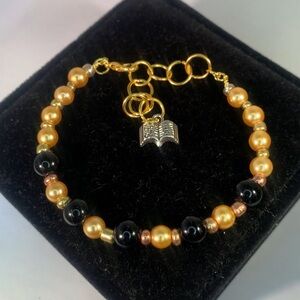 GOLDEN STORYLINE — Handmade Gold & Black Glass Beaded Bracelet with Book Charm